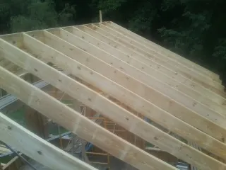 New roof rafters set over an addition before sheathing in Callicoon Center