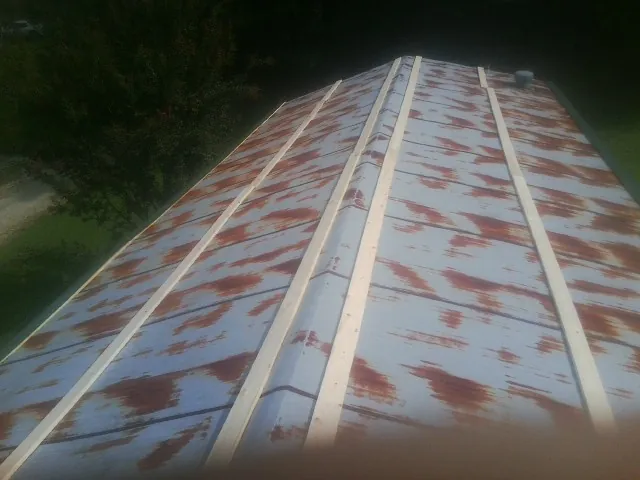 Rusted metal roof panels with new wood purlins before replacement — Storm Damage Roof Repair in Callicoon Center by Roofing Brothers